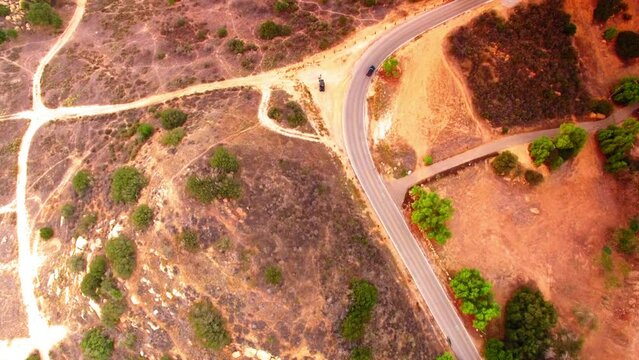 Aerial Top Forward Shot Of Cars Moving On Road Of Semi Arid Hill - Simi Valley, California