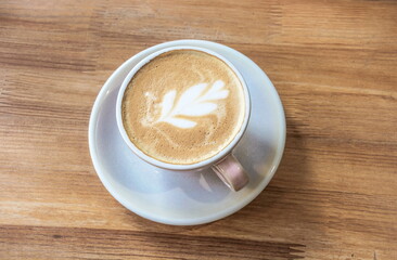 Cappuccino cup on a wooden countertop background