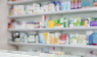 Shelves with pharmaceuticals in drugstore, blurred view. Banner design