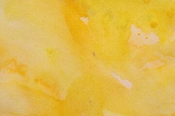 Abstract yellow watercolor painting as background, top view