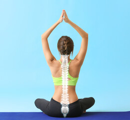 Beautiful young woman practicing yoga on color background