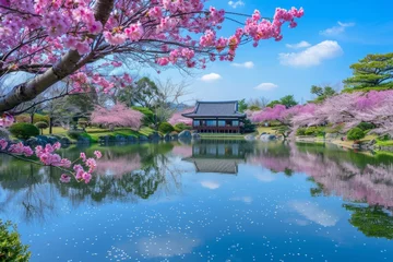 Zelfklevend Fotobehang Beautiful Japanese garden with cherry blossom trees, a lake and blue sky with their reflection in nature creating a peaceful landscape Generative AI © SKIMP Art