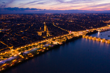 Picturesque view from drone of illuminated modern cityscape of French port city of Bordeaux on river Garonne and Stone Bridge