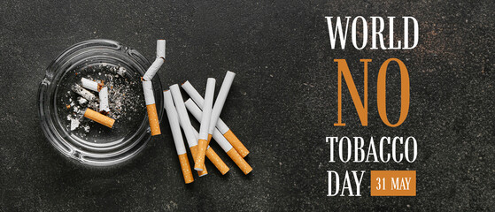 Many cigarettes and ash tray on dark background