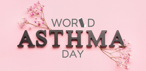 Word ASTHMA with flowers on pink background