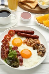 Delicious breakfast with sunny side up eggs on white wooden table