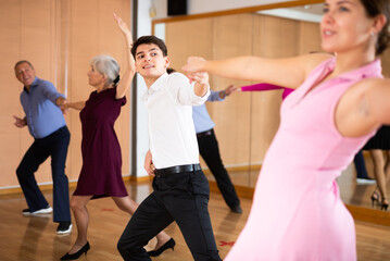 at dance lesson for beginners, young couple learn to dance jive