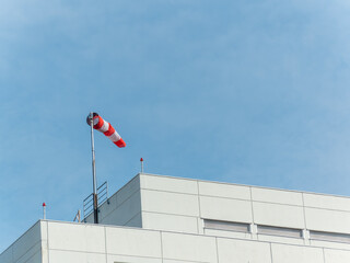 A windsock is a visual wind direction indicator on the top of the building