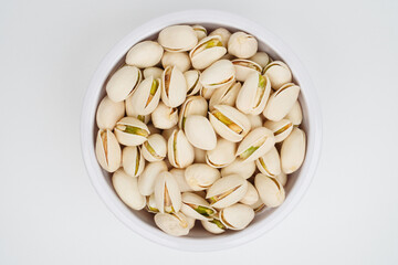 Pistachio nuts in a white bowl