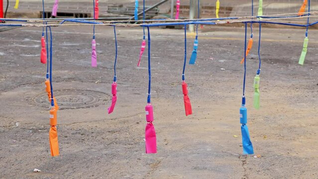 Mascleta fireworks in the local district of Valencia to celebrate traditional holiday.Firecrackers hanging on a thread in city street.