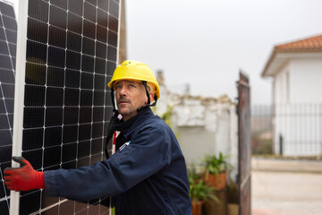 worker carrying solar panel while looking up