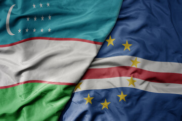 big waving national colorful flag of cape verde and national flag of uzbekistan.