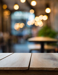 Empty old wooden table in front of abstract blurred bokeh background of a coffee shop full of people coming to use the service. Can be used for display or montage for show your products