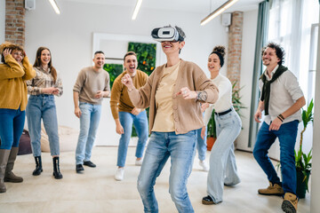 Naklejka premium One woman in front group of friends enjoy virtual reality VR headset