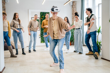 One woman in front group of friends enjoy virtual reality VR headset