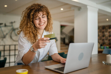 Woman happy caucasian female shopping online use credit card at cafe