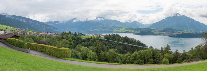 panoramic landscape above tourist resort Sigriswil, view to rope bridge and lake Thunersee