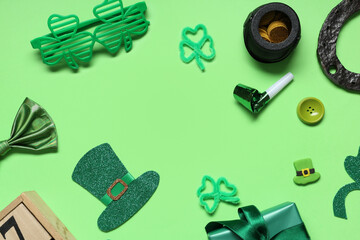 Frame made of eyeglasses with gift box, party whistle and decor for St. Patrick's Day on green...