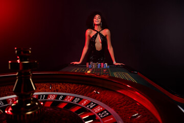 Photo of of happy addicted lady all in poker look excited rotating fortune wheel wait for...