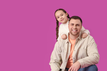 Fototapeta premium Father and his daughter on pink background
