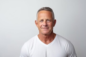 Portrait of a handsome mature man on grey background. Mature man. - obrazy, fototapety, plakaty