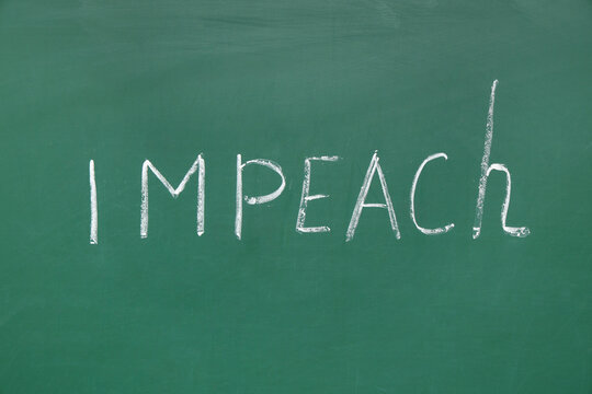 Word IMPEACH written on chalkboard