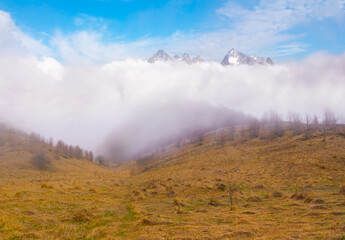 mountain valley in dense mist and clouds