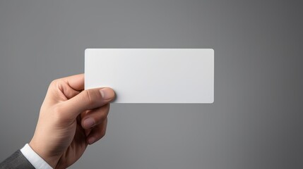 One hand Hand holds a business card
