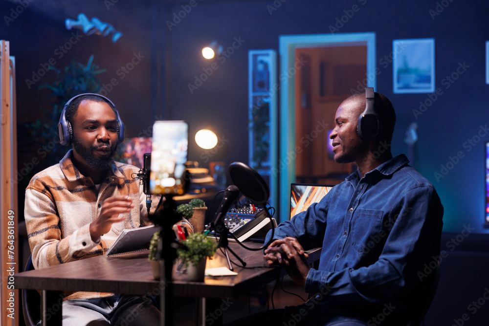 Poster during a marathon online stream for humanitarian cause, man records a podcast using cellphone on a t
