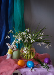 A still life arrangement of Easter eggs, spring flowers. Still life with snowdrops and ester eags. - 764364036