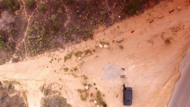 Aerial: Drone Top Downward Shot Of Men With Off-Road Vehicle Standing On Hill - Simi Valley, California