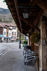 Fototapeta na wymiar Authentic village ambiance: café terraces, cobblestone streets Cabrales Asturias renowned gastronomy