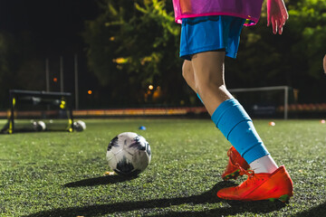 closeup shot of a football player getting ready to kick a soccer ball, stadium, sportswear, active life. High quality photo