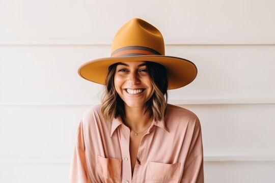 Portrait of a beautiful young woman wearing hat smiling at the camera