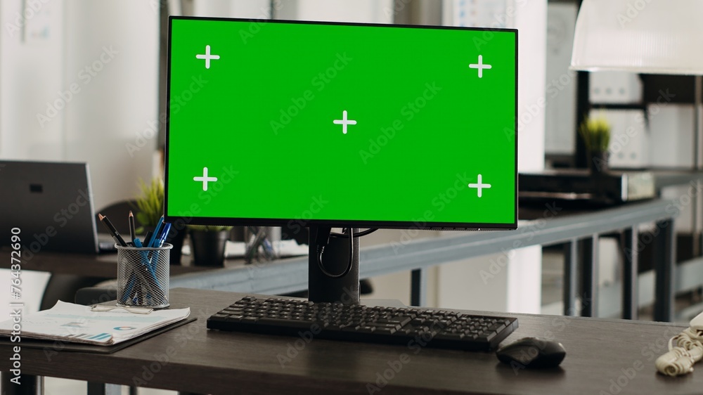 Poster workstation desk with greenscreen monitor in business agency office, empty coworking space with mode