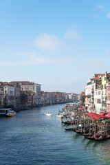  the Grand canal in Venice, Italy with boats and buildings on both sides, clear blue sky, sunny day, no clouds