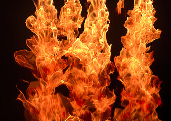 Whipping yellow-orange flames. Flaming dangerous burning tongues on black background, abstract wallpaper, background.