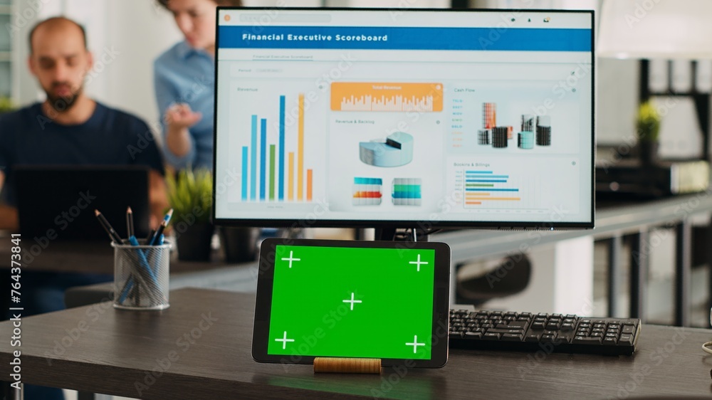 Poster workstation with greenscreen on tablet device in collaborative workspace for creative firm. in small