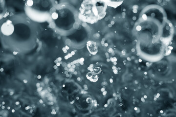 Macro shot of drop pearl bubbles on water