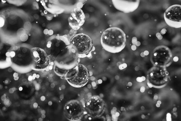 Macro shot of drop pearl bubbles on water