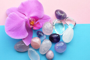 Fototapeta na wymiar Amethyst crystals, rose quartz and orchid flower. Healing crystals, the magic of precious stones.