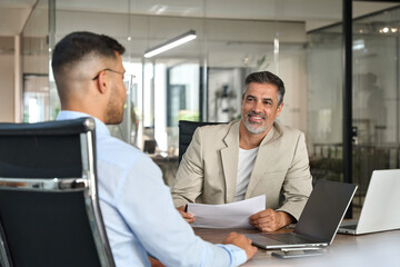 Financial advisor, professional bank manager consulting business man working on laptop in office....
