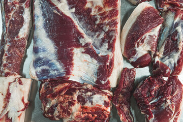 Stack of pig meat in butcher's shop, big slices of pork. High quality photo