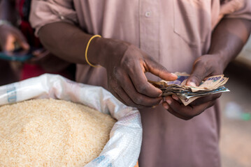 A man counts naira notes received as payment for rice at Bodija Market in Oyo, Nigeria on Monday,...