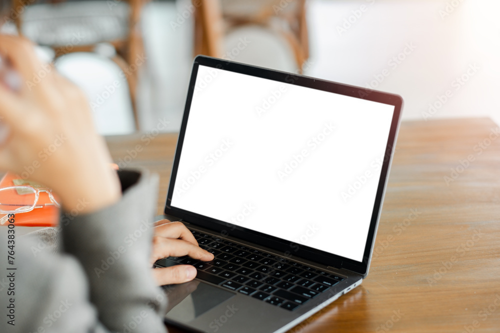 Poster close-up back view of a business woman working in the office typing, looking at the screen. office w