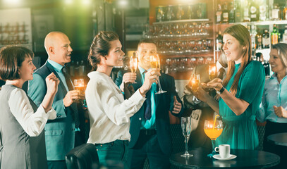 Fototapeta premium Portrait of two girls having fun and talking at a corporate party