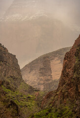 The Rock Pillar Standing Below A Snowy Cliff In Monument Creek