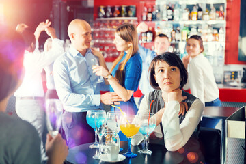 Portrait of woman tired during corporate party