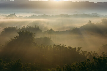 Autumn sunrise at Erh-liao, a low altitude hilly town in southern Taiwan, constitutes a misty...