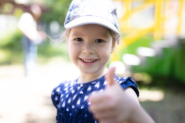 Happy young girl showing thumb up